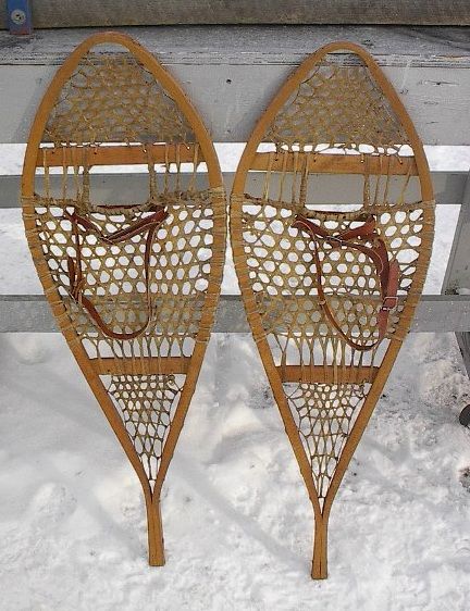 lot of snowshoes toboggans skis paddles and oars listed with a wide 